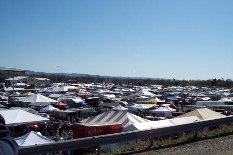 2001 Ford Crown Victoria - A wide view of a bustling outdoor market with numerous tents and stalls set up.