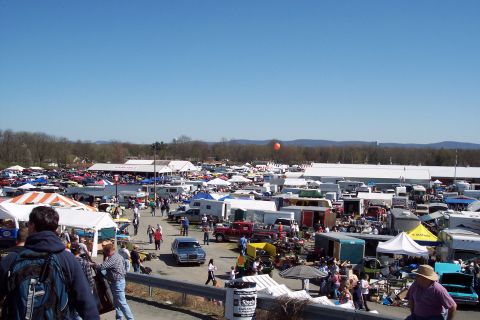 2001 Ford Crown Victoria - A blue sedan is parked at an outdoor event with many other vehicles and vendors.