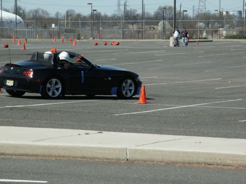 2001 Mercury Grand Marquis - A black convertible sports car navigates a cone-marked course during an event.