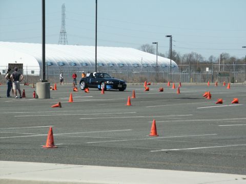 2001 Mercury Grand Marquis - A black convertible sports car navigates a course marked by orange traffic cones.