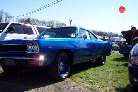 2001 Ford Crown Victoria - A bright blue 1968 Plymouth is parked on grass at an outdoor event, with other vehicles and people around.