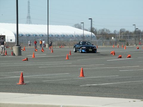 2001 Mercury Grand Marquis - Sports car driving through an autocross course marked by orange cones.