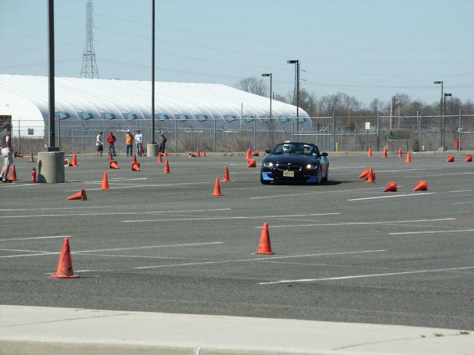 Black BMW Z4 convertible driving through cones on a track
