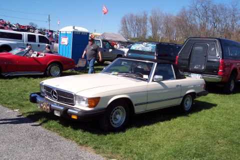 2001 Ford Crown Victoria - A cream-colored Mercedes-Benz SL convertible is parked on grass at an outdoor event with other vehicles visible.