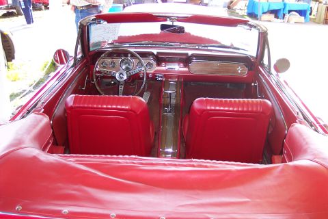 2001 Ford Crown Victoria - Interior view of a classic red convertible, its vintage dashboard and seating.