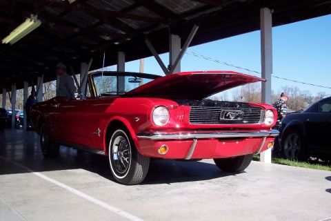 2001 Ford Crown Victoria - Red 1965 Ford Mustang convertible with its hood open, seen at an outdoor event.