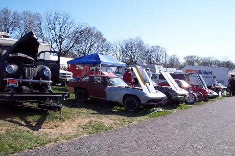 2001 Ford Crown Victoria - Cars are displayed for sale at an outdoor event, with a variety of vehicles visible.
