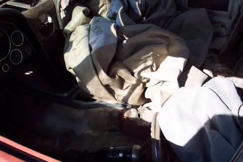 2001 Ford Crown Victoria - The interior of a car is shown, with the seats covered in protective fabric that has some visible text.