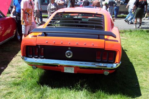 2001 Ford Crown Victoria - Rear view of an orange 1970 Ford Mustang Mach 1, louvers and a spoiler.