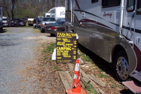 2001 Ford Crown Victoria - An RV motorhome is parked next to a sign detailing parking and camping fees.