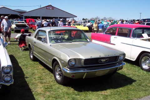 2001 Ford Crown Victoria - A classic 1965 Ford Mustang is displayed at an outdoor car show with other vehicles present.