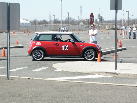 2001 Mercury Grand Marquis - Red Mini Cooper participating in an autocross event, driver wearing a helmet.