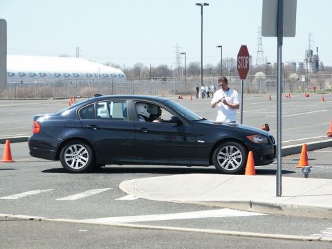2001 Mercury Grand Marquis - Autocross event with a dark sedan and a driver in a helmet navigating the course.
