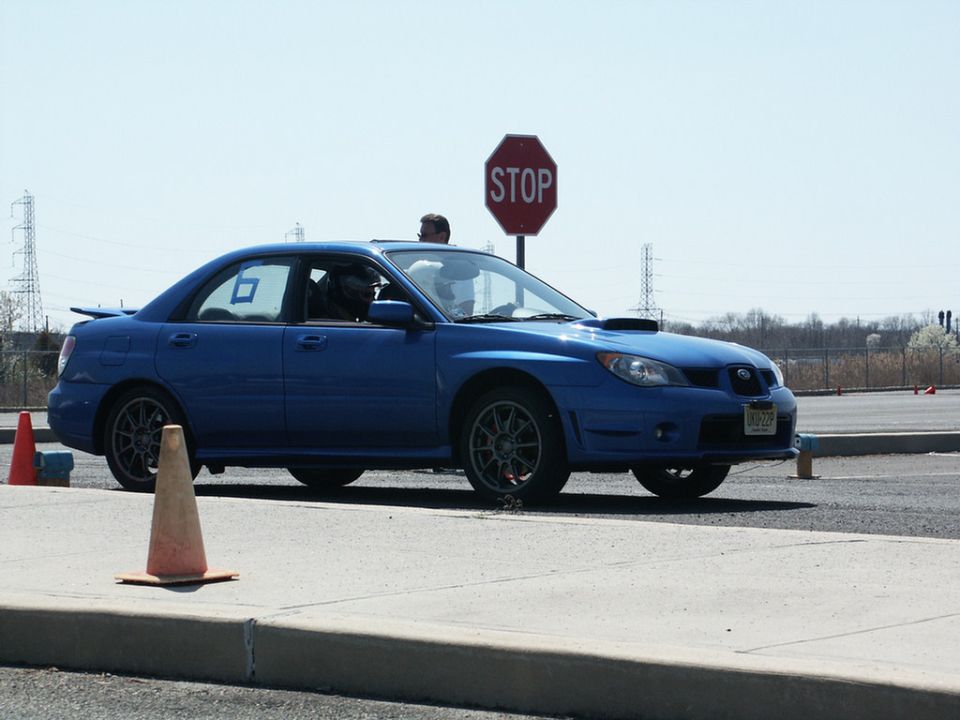Blue Subaru Impreza WRX with racing cones and a stop sign