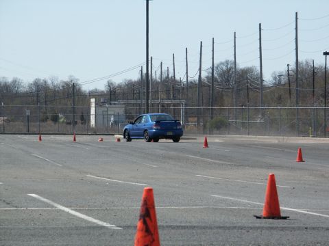 2001 Mercury Grand Marquis - A blue sedan navigates a course marked by orange cones during an event.