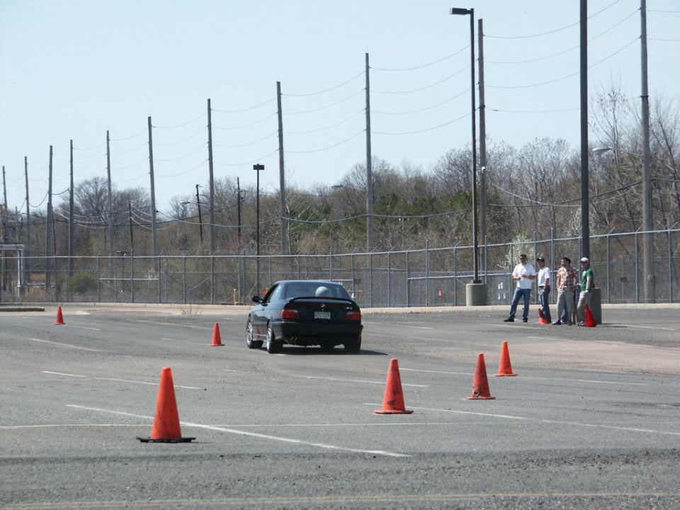 Black BMW M3 on a track with orange cones