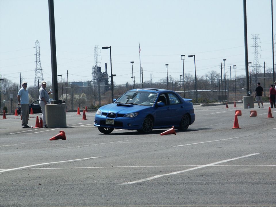 Blue Subaru Impreza WRX sedan navigating a cone course