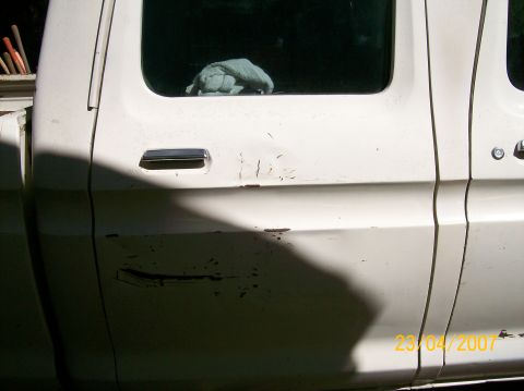 1978 Ford F-250 - Close-up of a white pickup truck's side doors, showing wear and tear. A date stamp indicates 2007.