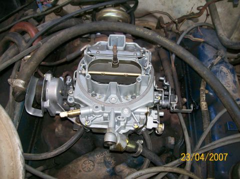 1978 Ford F-250 - A Motorcraft carburetor is visible in the engine bay, surrounded by various hoses and electrical components.