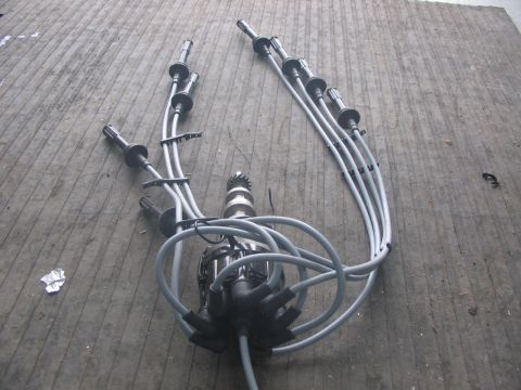 1964 Ford 427 - Ford distributor and spark plug wires on a wooden surface.