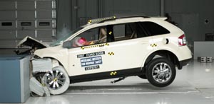 1971 Ford Ranchero - A white SUV is shown after a crash test, with significant damage to its front end and deployed airbags.