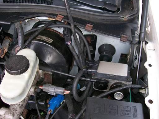 Engine bay showing brake booster, master cylinder, and wiring