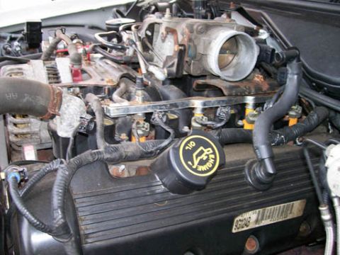 1999 Ford Crown Victoria - Close-up view of an engine bay, showing various components and wiring harnesses.