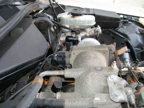 1999 Ford Crown Victoria - Close-up view of a vehicle's engine bay, showing mechanical and electrical components.