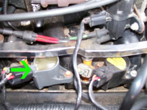 1999 Ford Crown Victoria - Close-up view of engine ignition coils and associated wiring, showing electrical connectors and spark plug wires.