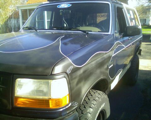 1993 Ford Bronco - Front 3/4 view of a 1993 Ford Bronco custom flame graphics.