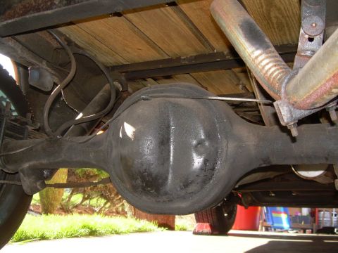 1971 Ford F-100 - The underside of a 1971 Ford F-100 reveals its rear differential and exhaust components.