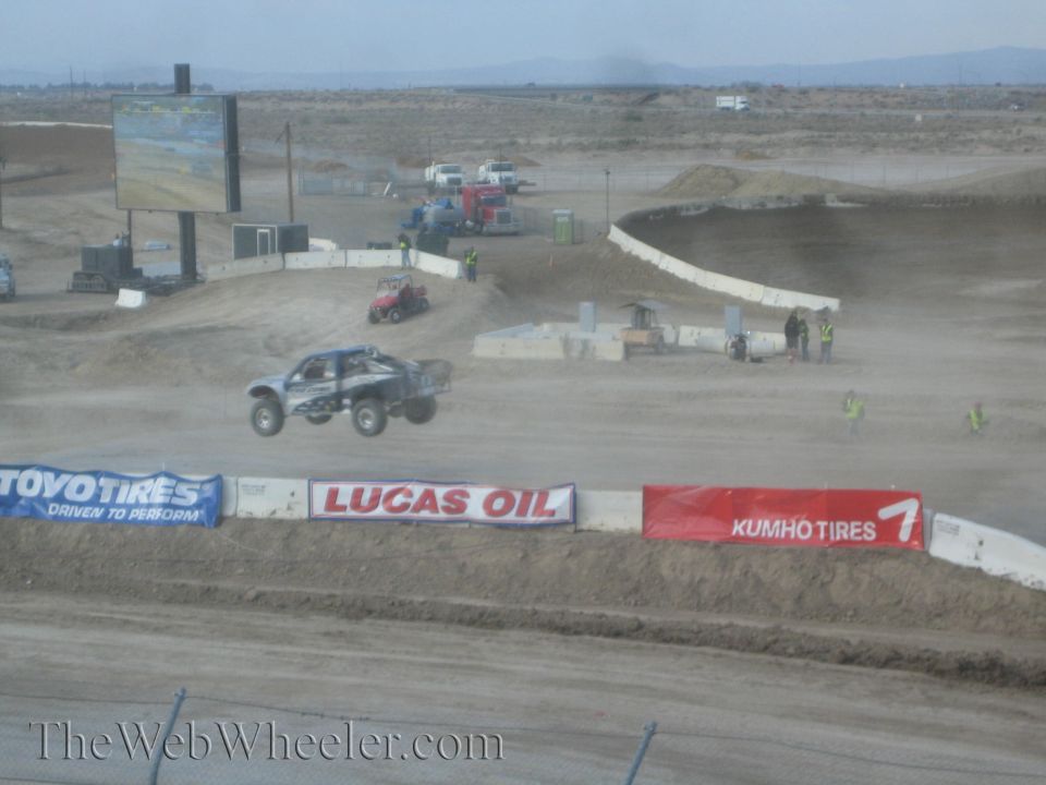 Off-road race truck jumping on a desert short-course track