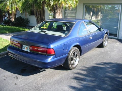 1995 Ford Thunderbird - Rear view of a blue 1995 Ford Thunderbird coupe parked in a driveway.