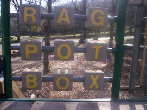 1989 Ford Bronco - Alphabet blocks on a playground spell out RAG POT BOX.