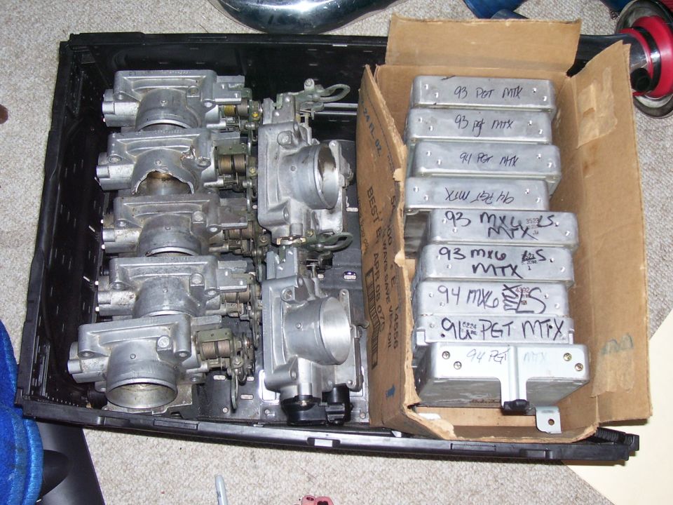 Throttle bodies and engine control units labeled '93 MX-6'