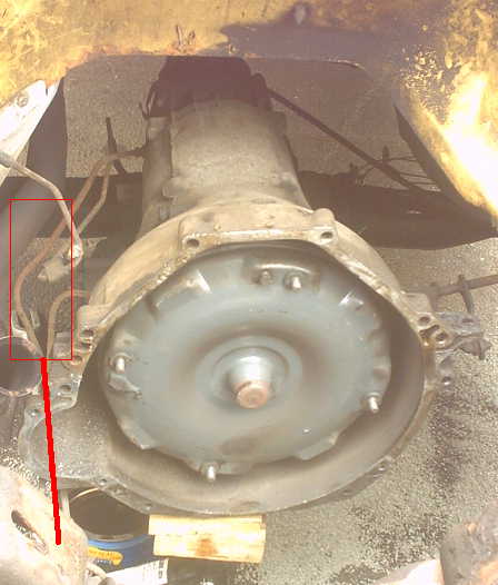 1979 Ford Bronco - Close-up of a vehicle's transmission and torque converter, showing mechanical components.