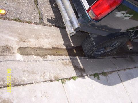 1996 Ford F-350 - The rear corner of a 1996 Ford F-350 pickup truck is visible, showing the taillight and exhaust pipes.