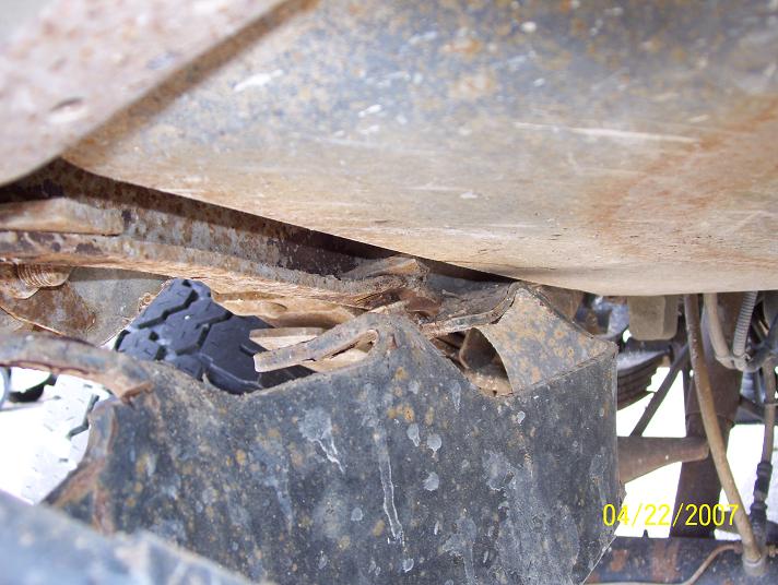 Undercarriage detail with visible rust and a tire fragment; dated 04/22/2007
