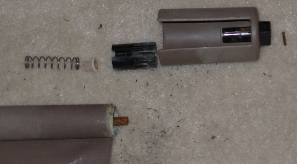 After driving out the LEFT roll pin (use a 3/32" drift), the torque plate, bearing, spring, and spring caps (one still inside) can be removed and cleaned.