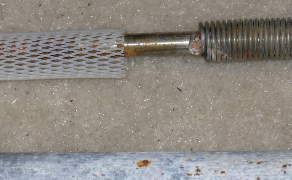 The torque spring is riveted to the rod - don't remove it.  The rattle-mesh slides off easily.