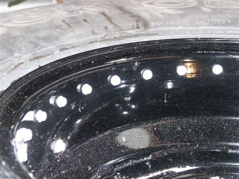 1991 Ford Bronco - A close-up view of a vehicle's tire and rim, showing wear and tear.
