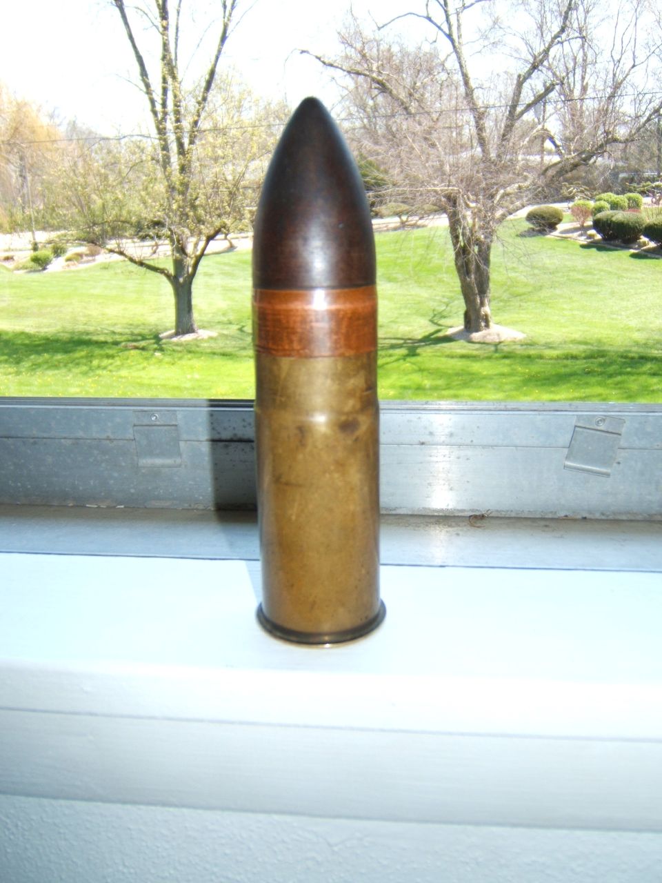 Artillery shell with brass casing and dark projectile