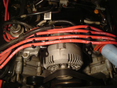 1992 Ford Crown Victoria - Close-up view of engine components, including spark plug wires and alternator.