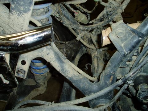 2000 Ford E350 - Undercarriage view of vehicle suspension and electrical wiring, no specific year identified.