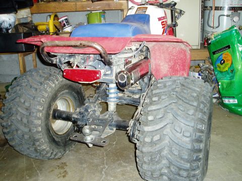 2000 Ford E350 - This Honda ATV is shown from the rear, equipped with large, off-road tires and a trailer hitch.