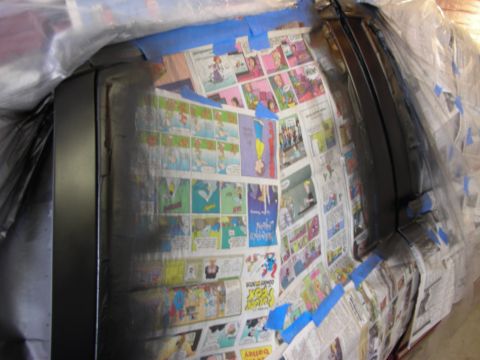 1992 Ford Crown Victoria - Car door masked with comic strips and newspaper for painting.