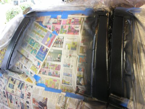 1992 Ford Crown Victoria - Newspaper and tape cover the interior of a car during preparation for painting.