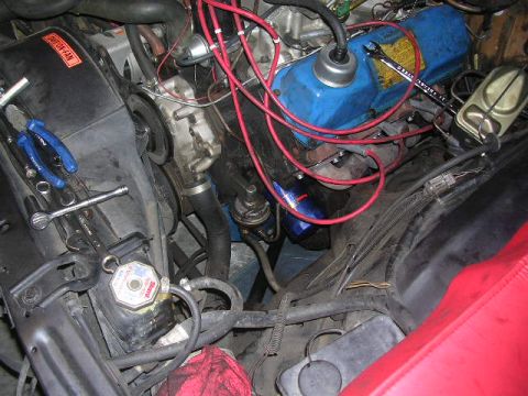 1975 Ford Ranchero - A close-up view of a vehicle's engine bay, showing various mechanical parts and tools.