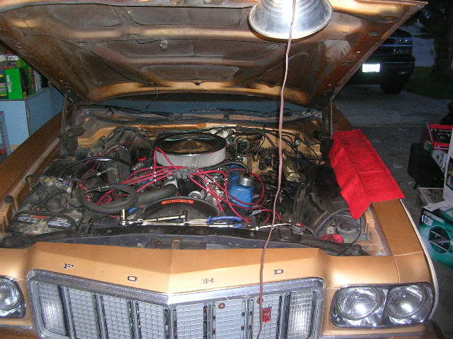 Gold 1975 Ford Ranchero engine bay with chrome air cleaner and red spark plug wires