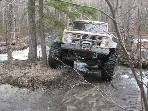 1990 Ford F-250 - This modified vehicle is equipped for extreme off-roading through challenging muddy terrain.